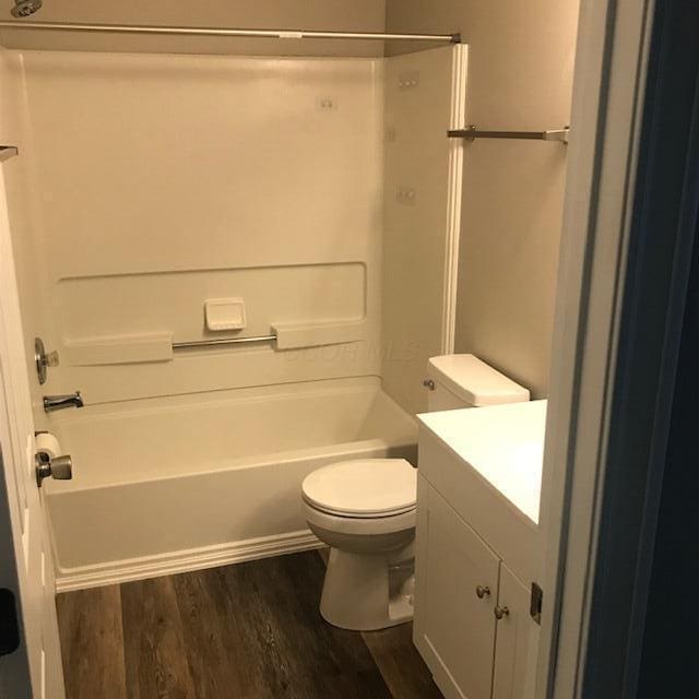 1817 Ridgebury Dr, Hilliard, OH 43026 - bathroom featuring wood finished floors, toilet,  shower combination, and vanity