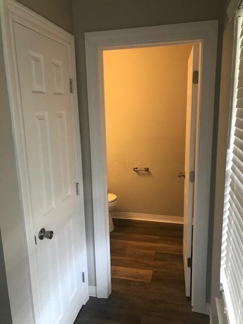 1817 Ridgebury Dr, Hilliard, OH 43026 - bathroom featuring baseboards, wood finished floors, and toilet