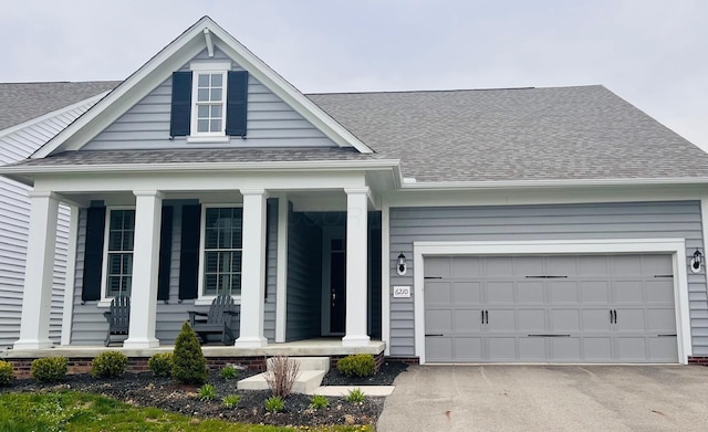 6210 Callaway Sq W, New Albany, OH 43054 - view of front of property featuring a porch, a shingled roof, a garage, and driveway
