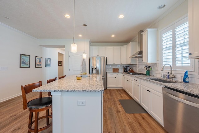 6210 Callaway Sq W, New Albany, OH 43054 - kitchen featuring stainless steel appliances, a sink, ornamental molding, wall chimney exhaust hood, and light wood-style floors