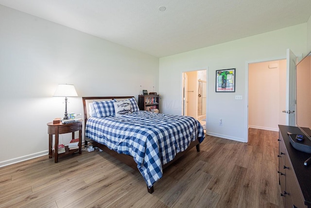 6210 Callaway Sq W, New Albany, OH 43054 - bedroom with wood finished floors, baseboards, and ensuite bathroom