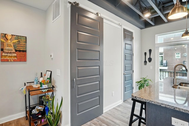 20 N Center St Unit 20, Springfield, OH 45502 - interior space featuring a sink, light wood-style floors, light stone counters, and baseboards