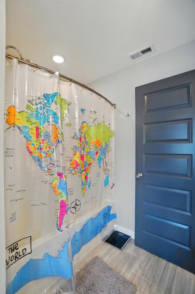 20 N Center St Unit 20, Springfield, OH 45502 - full bath featuring curtained shower, wood finished floors, and baseboards