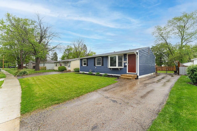 single story home featuring asphalt driveway