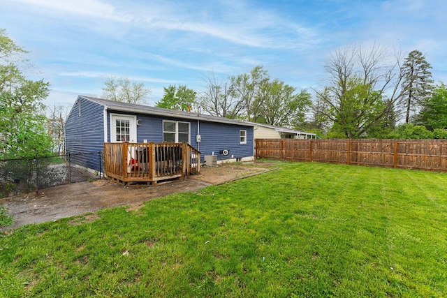 rear view of property featuring a wooden deck