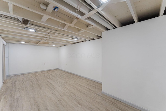 finished below grade area with wood finished floors and baseboards