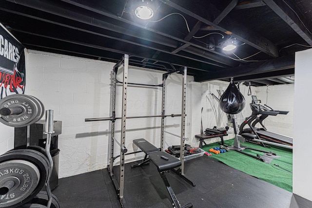 workout area featuring concrete block wall