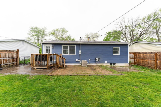 rear view of house featuring a wooden deck and central AC