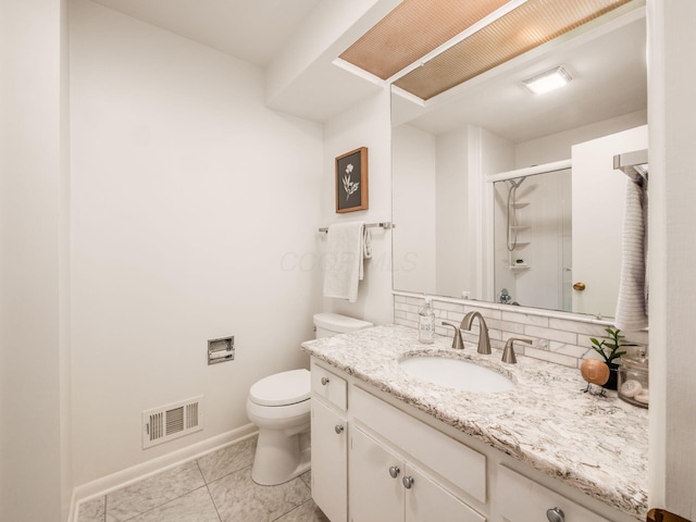 bathroom featuring a shower stall, toilet, baseboards, vanity, and marble finish floors