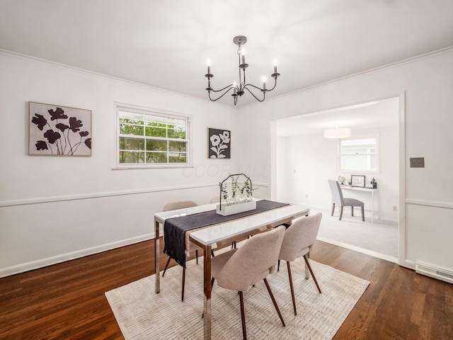 dining space with a chandelier, ornamental molding, dark wood-style flooring, and baseboards