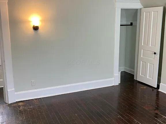 390 E Hinman Ave, Columbus, OH 43207 - spare room featuring baseboards and dark wood-type flooring