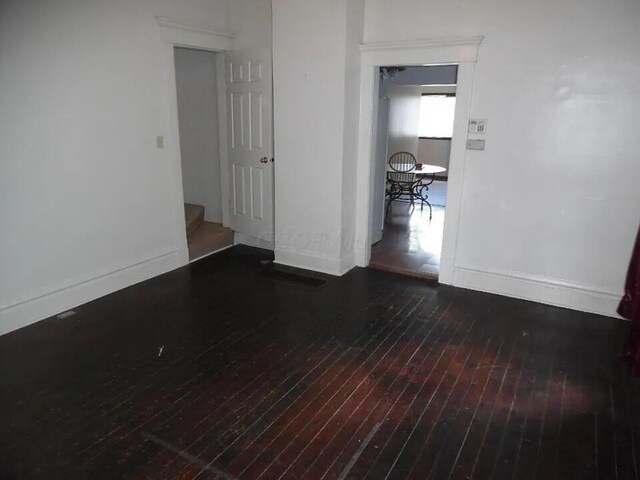 390 E Hinman Ave, Columbus, OH 43207 - empty room with hardwood / wood-style flooring, stairs, and baseboards