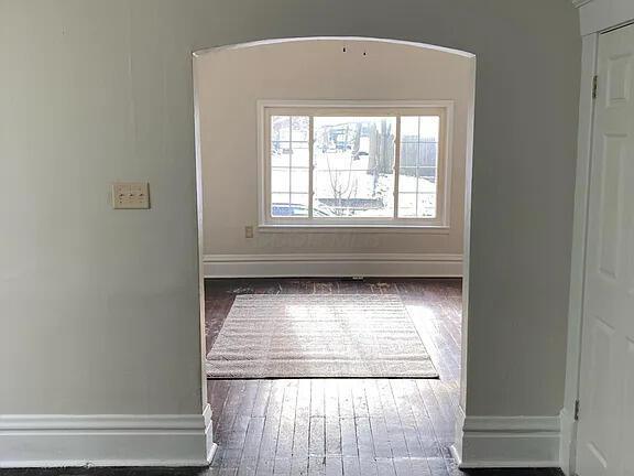 390 E Hinman Ave, Columbus, OH 43207 - spare room with baseboards and dark wood-style flooring