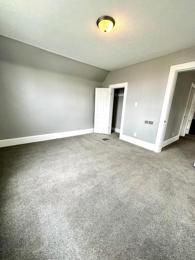 375 N Main St, Marion, OH 43302 - unfurnished bedroom featuring baseboards, carpet, a textured ceiling, lofted ceiling, and a closet