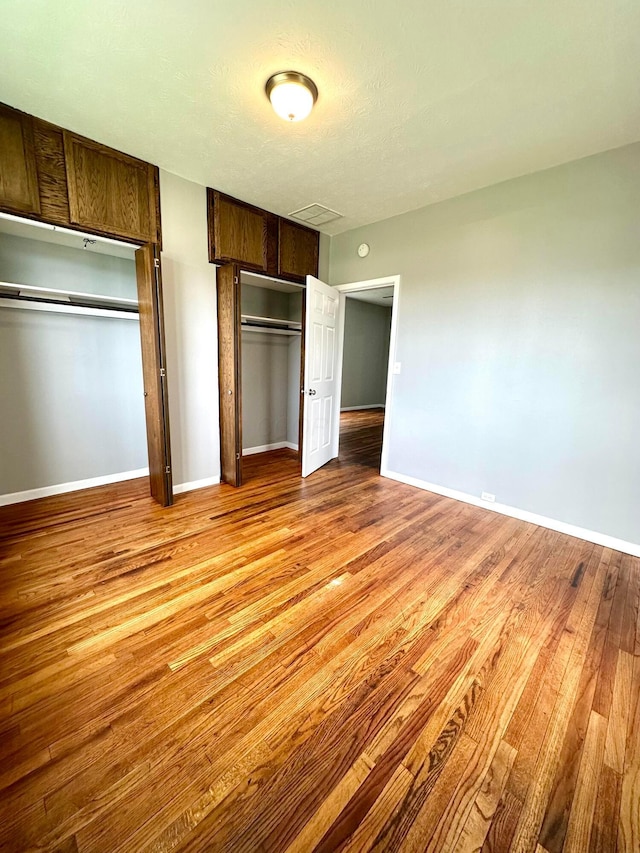 375 N Main St, Marion, OH 43302 - unfurnished bedroom featuring light wood-style flooring, two closets, and baseboards