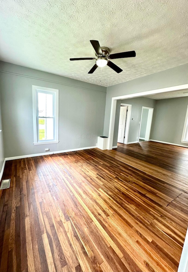 375 N Main St, Marion, OH 43302 - unfurnished bedroom with dark wood-type flooring, baseboards, a textured ceiling, and ceiling fan