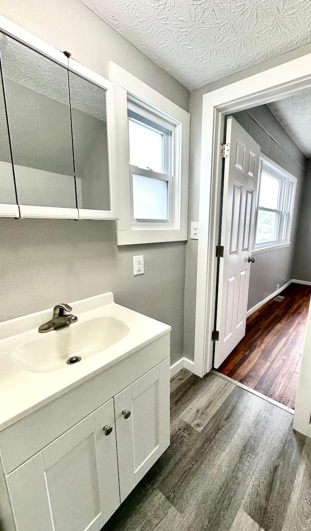 375 N Main St, Marion, OH 43302 - bathroom with wood finished floors, baseboards, a textured ceiling, and vanity