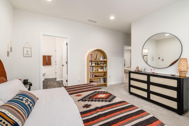 carpeted bedroom with recessed lighting, connected bathroom, and baseboards