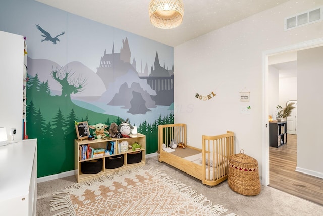 playroom featuring wood finished floors, baseboards, and carpet