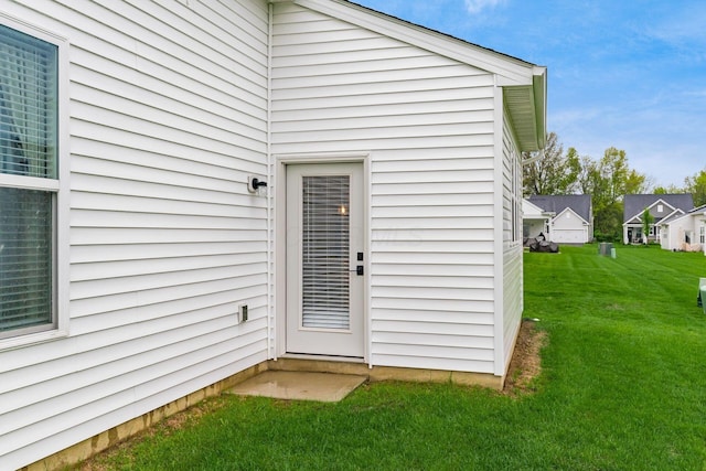 entrance to property featuring a yard