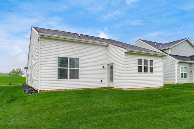 rear view of house with a lawn