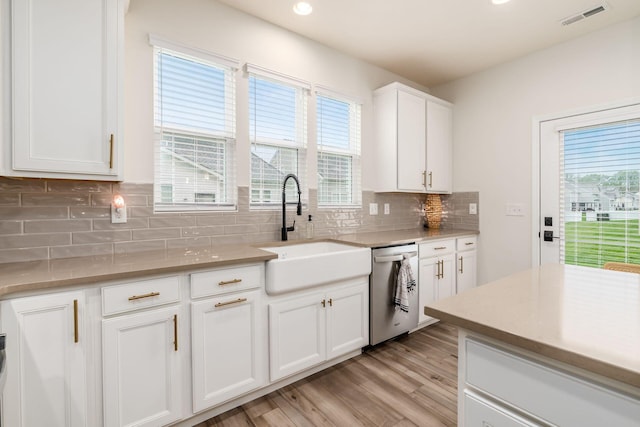 kitchen featuring a sink, stainless steel dishwasher, light wood-type flooring, healthy amount of natural light, and recessed lighting