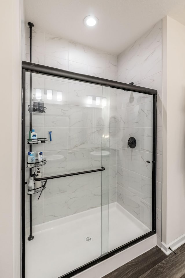 bathroom featuring a shower stall, recessed lighting, wood finished floors, and baseboards
