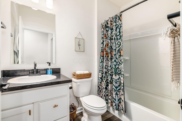 bathroom with toilet, vanity, wood finished floors, and shower / tub combo with curtain