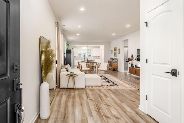 entrance foyer with light wood finished floors, recessed lighting, and baseboards