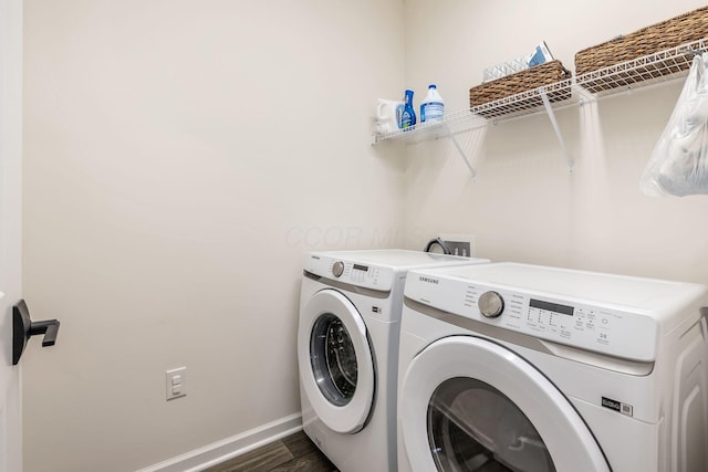 laundry area with independent washer and dryer, baseboards, and dark wood finished floors