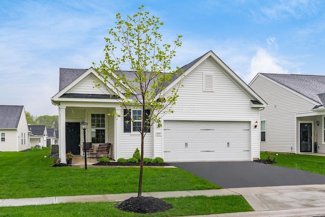 view of front facade featuring asphalt driveway, a front lawn, an attached garage, and a shingled roof