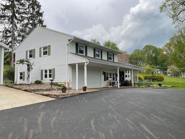 1893 Lovers Ln, New Lexington, OH 43764 - traditional-style home featuring driveway, a garage, and a chimney