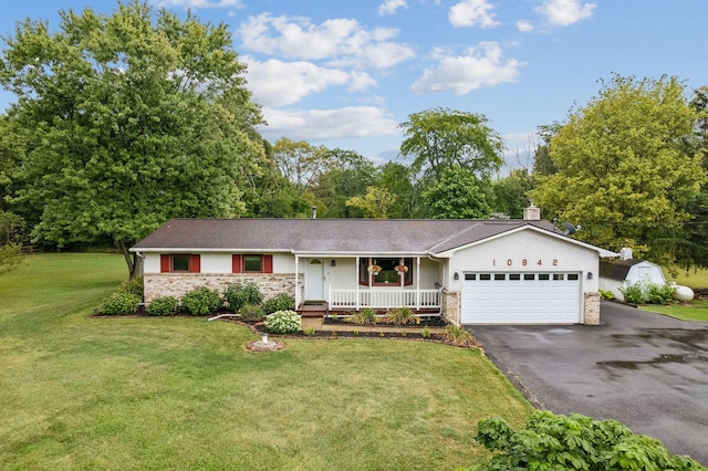 10842 Johnstown Rd, New Albany, OH 43054 - ranch-style house featuring a porch, an attached garage, stone siding, driveway, and a front yard