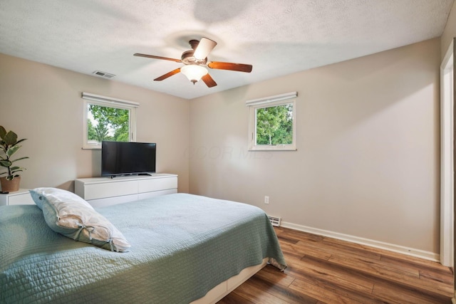 10842 Johnstown Rd, New Albany, OH 43054 - bedroom with hardwood / wood-style flooring, multiple windows, baseboards, ceiling fan, and a textured ceiling