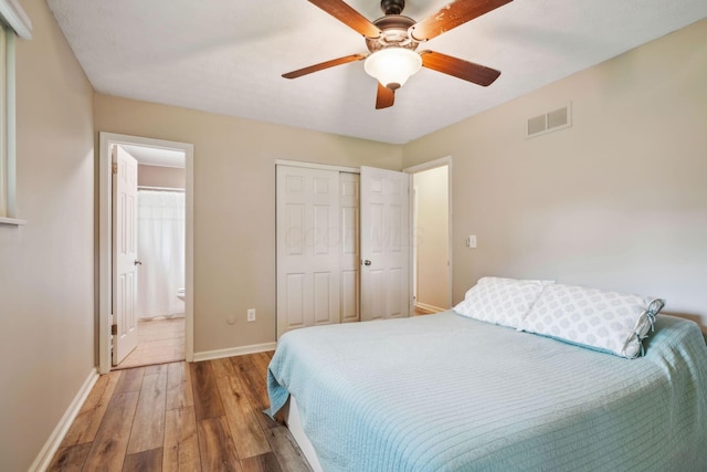 10842 Johnstown Rd, New Albany, OH 43054 - bedroom with hardwood / wood-style flooring, baseboards, ensuite bathroom, ceiling fan, and a closet