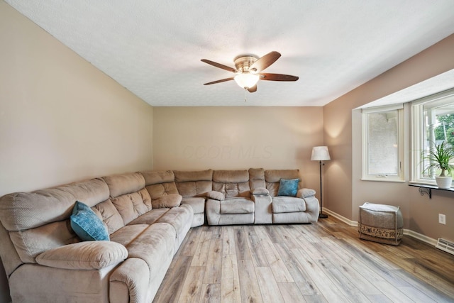 10842 Johnstown Rd, New Albany, OH 43054 - living room featuring light wood finished floors, a ceiling fan, and baseboards
