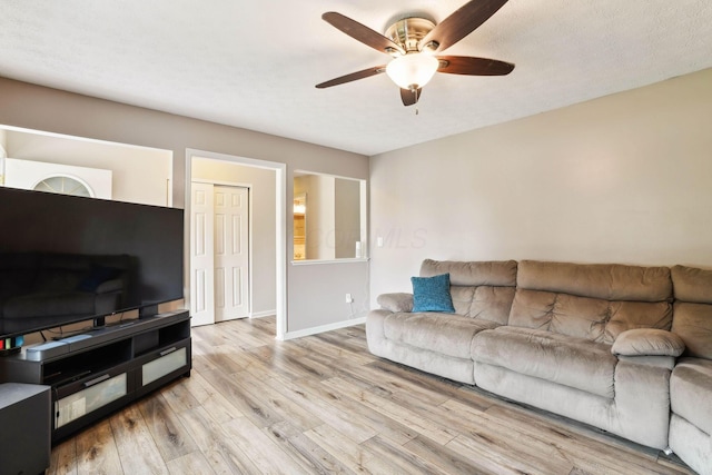 10842 Johnstown Rd, New Albany, OH 43054 - living room featuring ceiling fan, wood finished floors, and baseboards