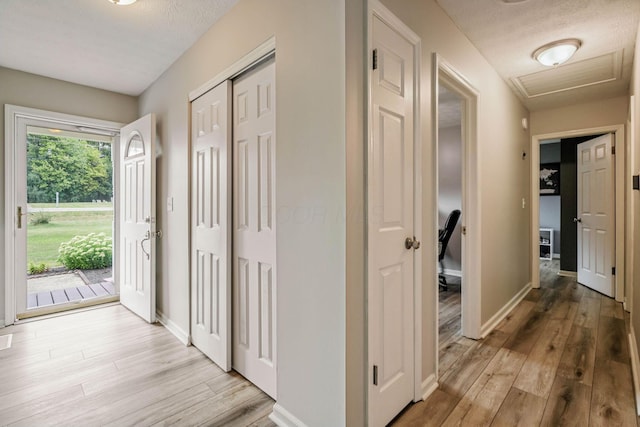 10842 Johnstown Rd, New Albany, OH 43054 - hall featuring light wood-type flooring, attic access, and baseboards