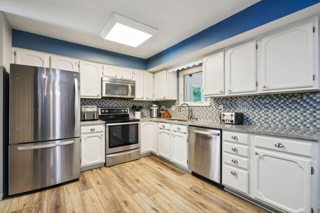 10842 Johnstown Rd, New Albany, OH 43054 - kitchen featuring stainless steel appliances, white cabinets, and a sink