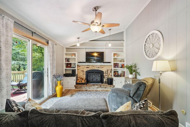 10842 Johnstown Rd, New Albany, OH 43054 - living area with lofted ceiling, crown molding, wood finished floors, ceiling fan, and a wood stove