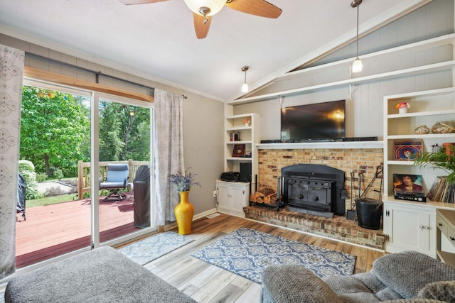 10842 Johnstown Rd, New Albany, OH 43054 - living room with vaulted ceiling, a wood stove, crown molding, wood finished floors, and ceiling fan