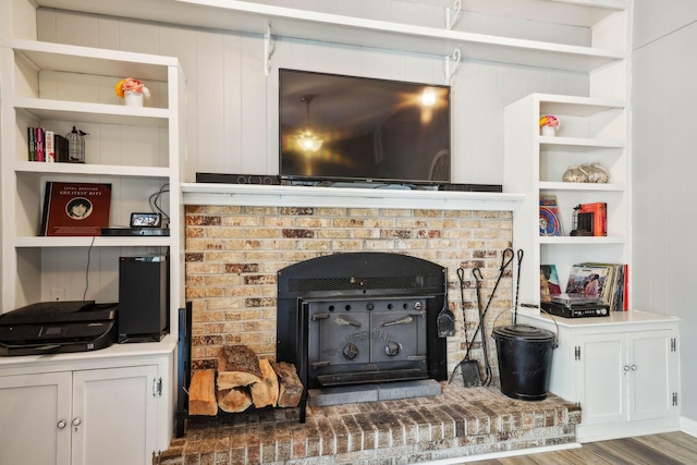 10842 Johnstown Rd, New Albany, OH 43054 - detailed view of a wood stove, wood finished floors, and built in shelves