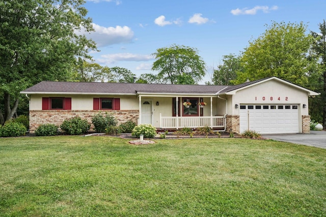 10842 Johnstown Rd, New Albany, OH 43054 - ranch-style home featuring covered porch, an attached garage, asphalt driveway, brick siding, and stucco siding