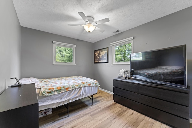 10842 Johnstown Rd, New Albany, OH 43054 - bedroom featuring wood finished floors, baseboards, a textured ceiling, and a ceiling fan