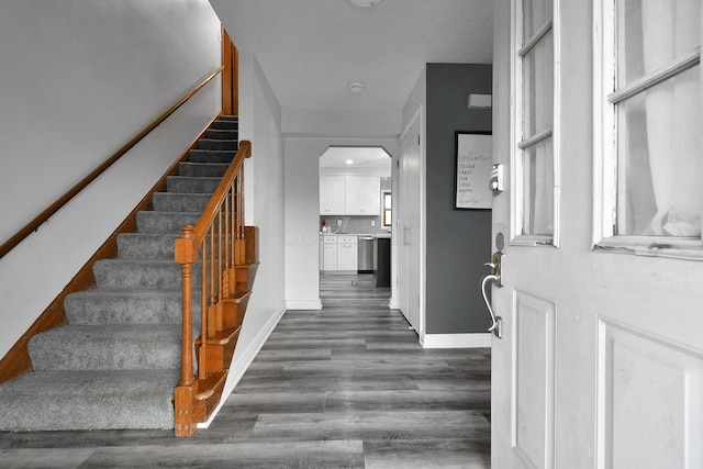 10129 Granden St, Pickerington, OH 43147 - entryway with dark wood-style floors, stairway, baseboards, and arched walkways