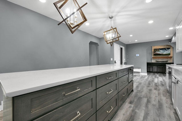 10129 Granden St, Pickerington, OH 43147 - kitchen with a chandelier, baseboards, wood finished floors, recessed lighting, and light countertops