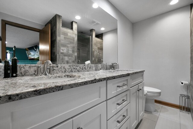 10129 Granden St, Pickerington, OH 43147 - bathroom featuring toilet, tiled shower, double vanity, recessed lighting, and baseboards