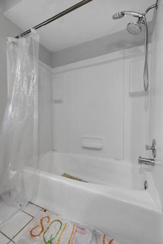 10129 Granden St, Pickerington, OH 43147 - bathroom featuring shower / bath combo with shower curtain and a textured ceiling