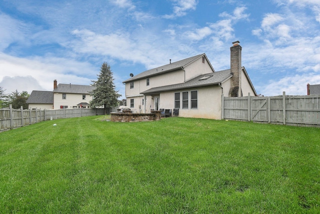 10129 Granden St, Pickerington, OH 43147 - back of house featuring stucco siding and a chimney