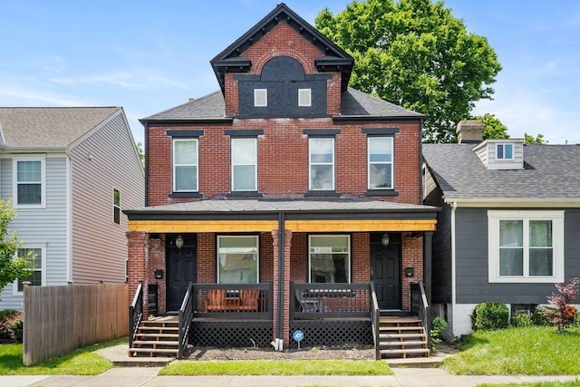 453-455 S 22nd St, Columbus, OH 43205 - view of front of house with a porch, brick siding, fence, and a shingled roof